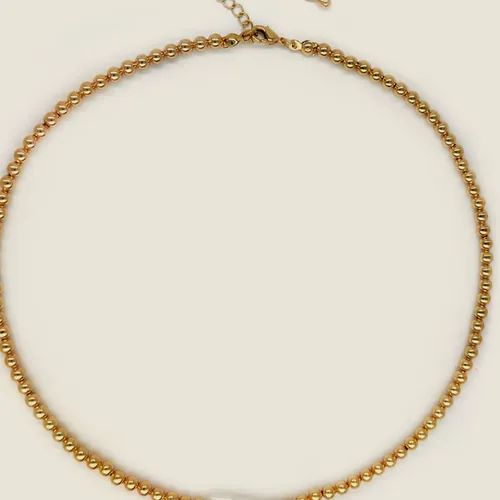 Gold-tone round-link chain necklace with an elongated pearl mounted at the front.