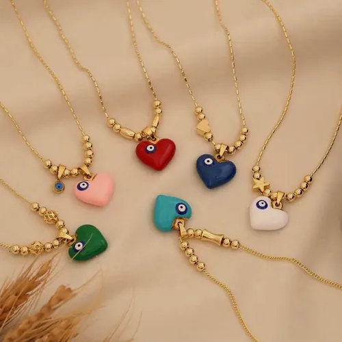 Six gold-tone chain necklaces with an enamelled heart pendant in pink, red, blue, turquoise, green and white.