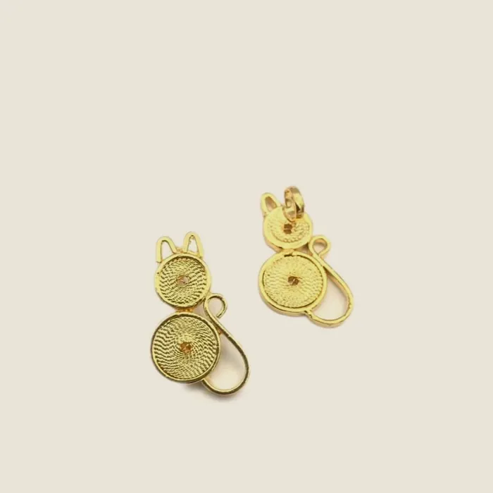 Small gold-tone filigree earrings made of two joined spirals.