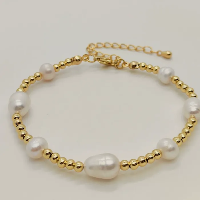Bracelet of freshwater pearls alternating with gold-tone beads and an extender clasp.