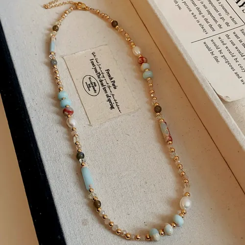 Necklace of colour stone beads alternating with pearls and gold-tone spacers.