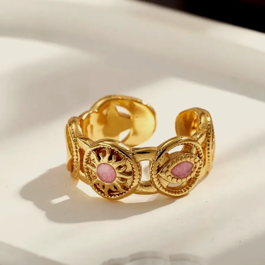 Wide ring with pink stones.