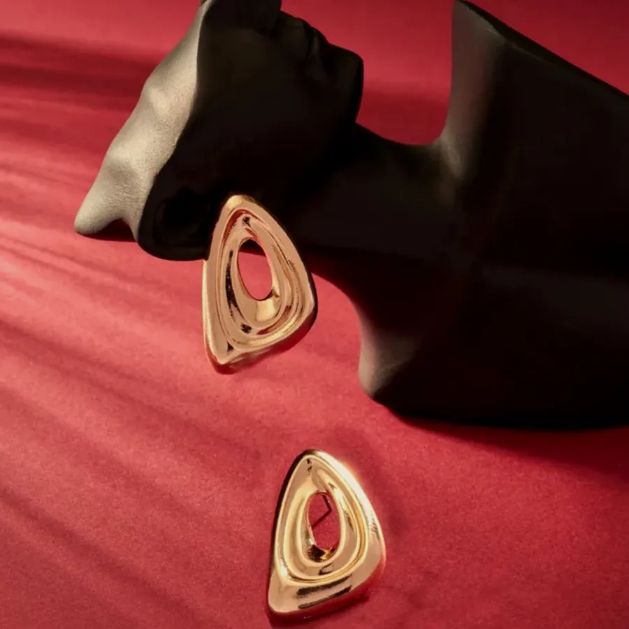 Open hoop earrings with pink enamel and a gold edge.