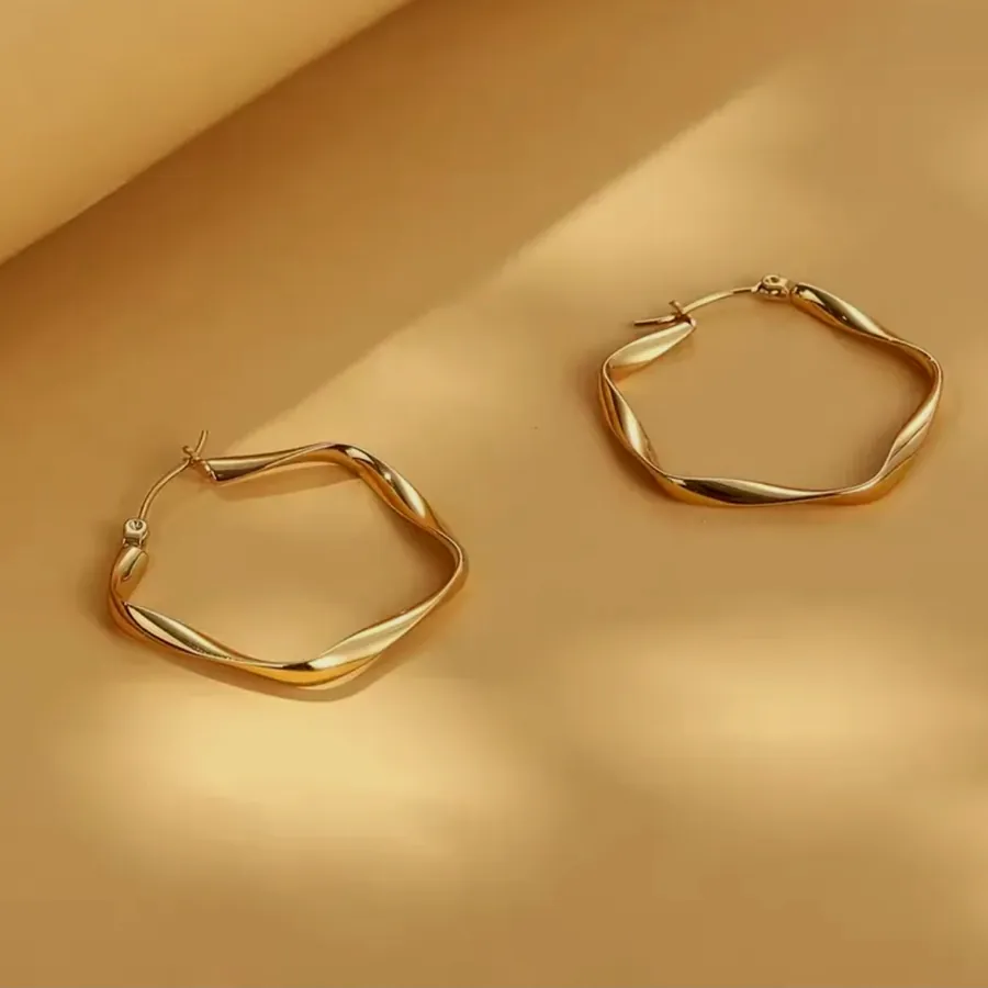 Wavy gold hoop earrings.