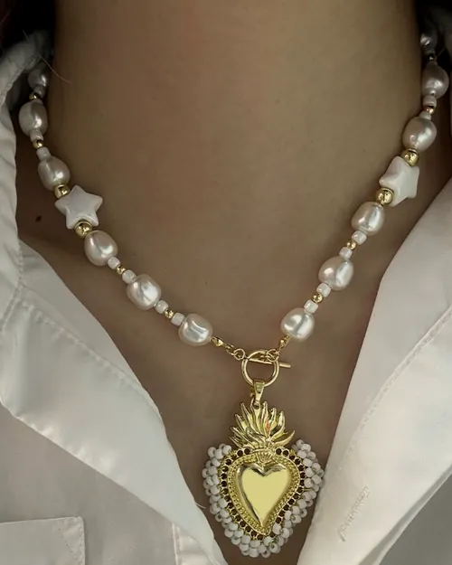 Pearl necklace with a sacred heart.