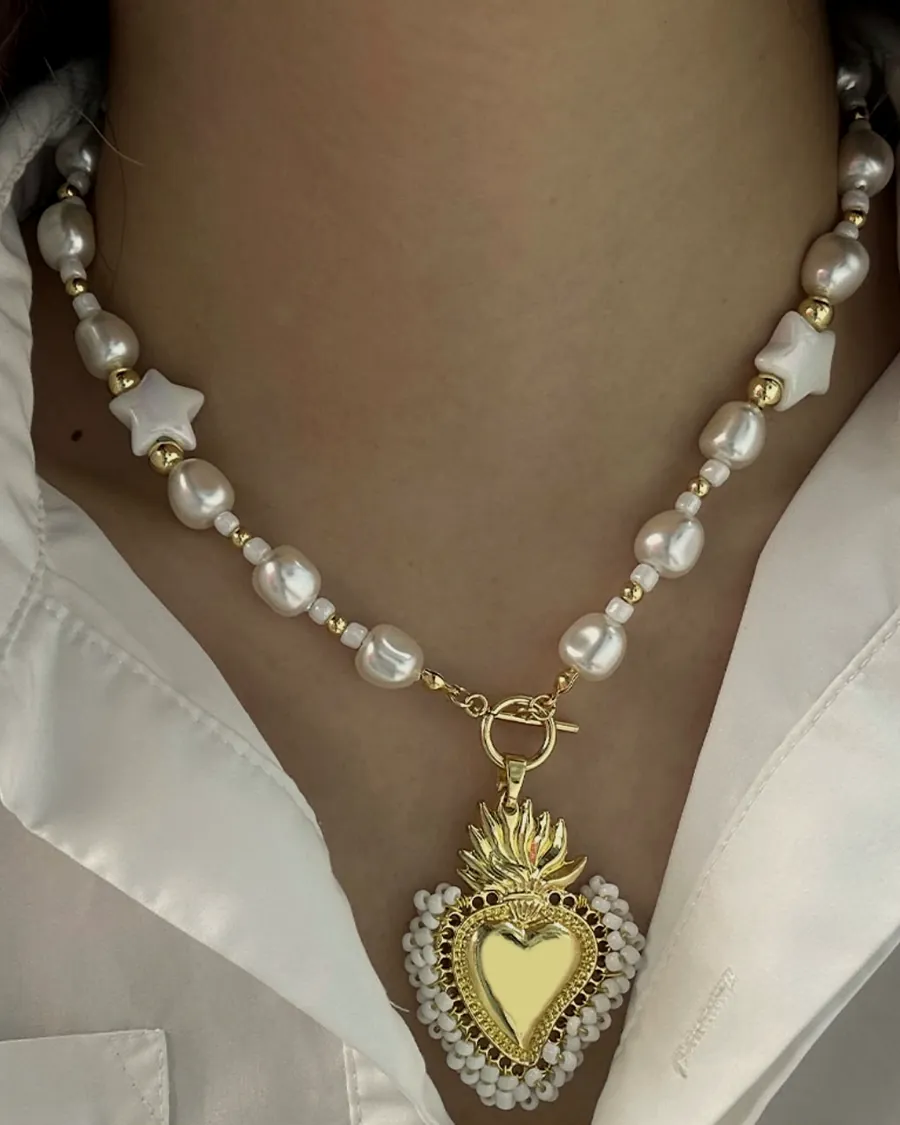Pearl necklace with a sacred heart.