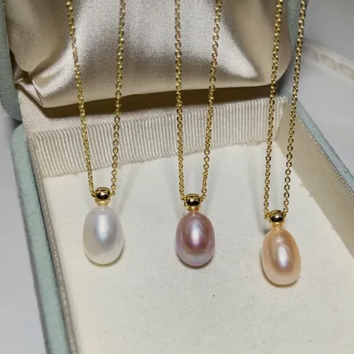 Three drop-pearl necklaces in different tones.