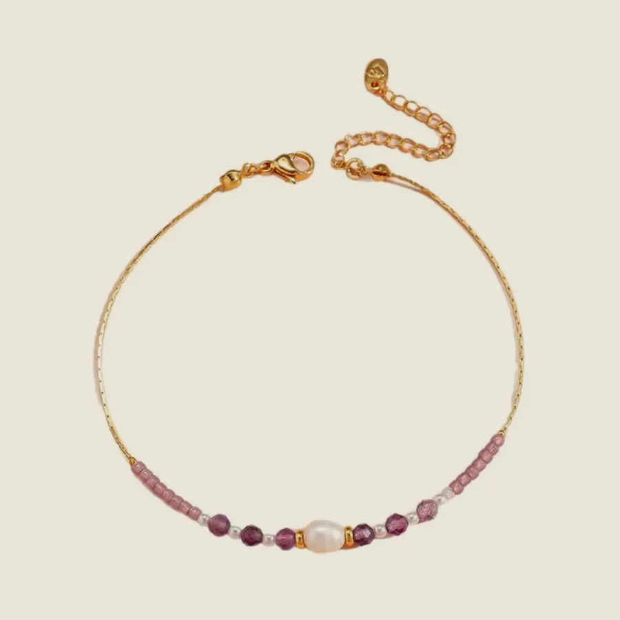 Pink woven bracelet with a stone.