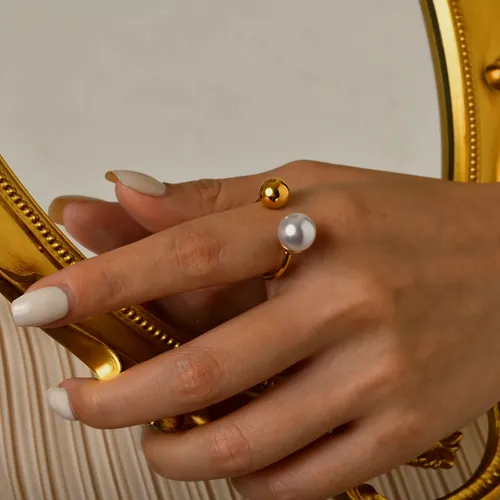 Open ring with gold ball and pearl.