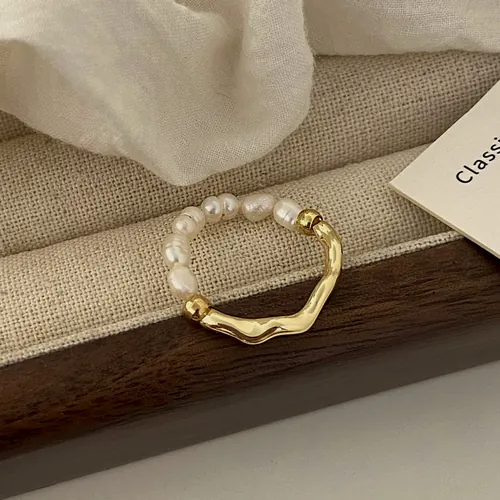 Curved gold ring with pearls.