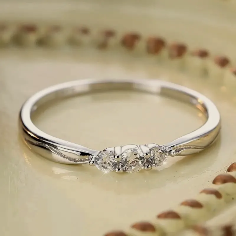 Silver-tone ring with three crystals.