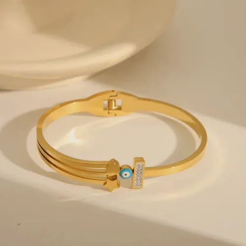 Gold bangle with a baguette crystal.