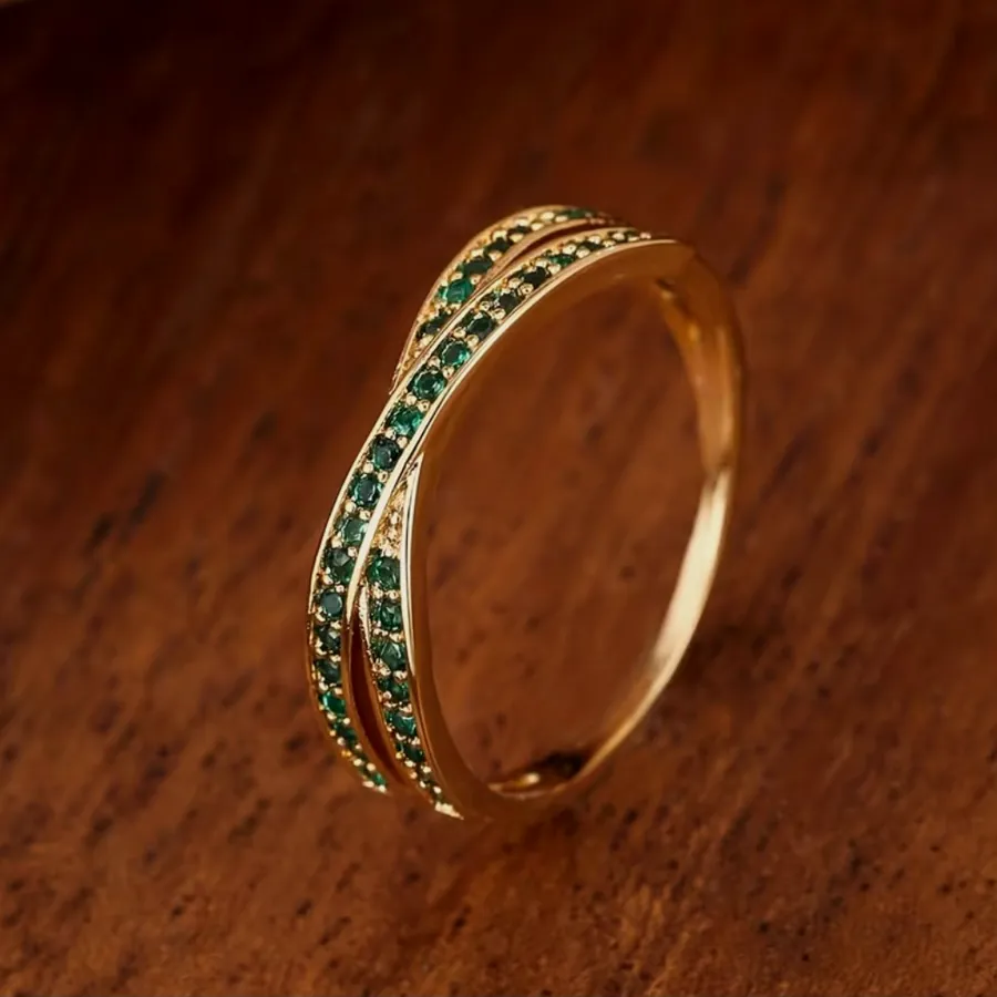 Gold ring with two crossing rows of green zirconia.