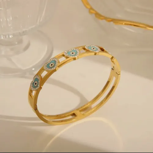 Gold bangle with evil eyes.