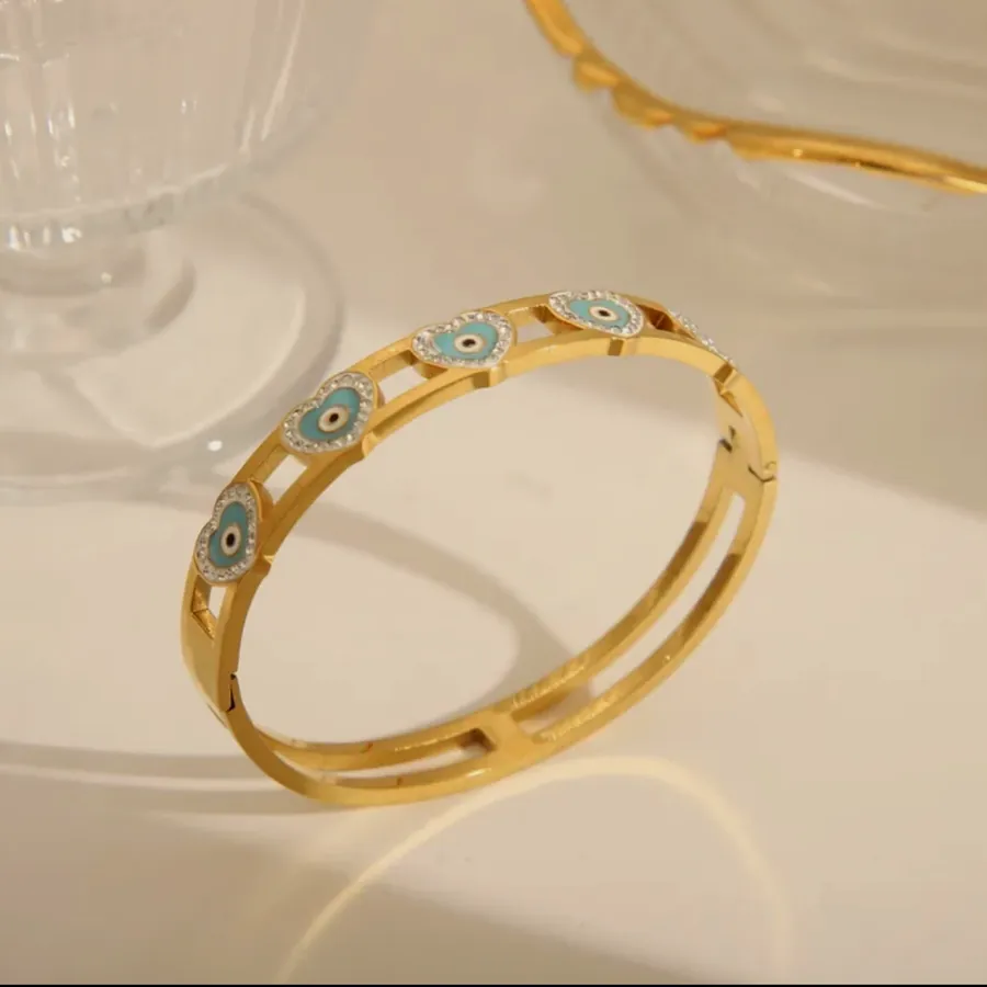 Gold bangle with evil eyes.