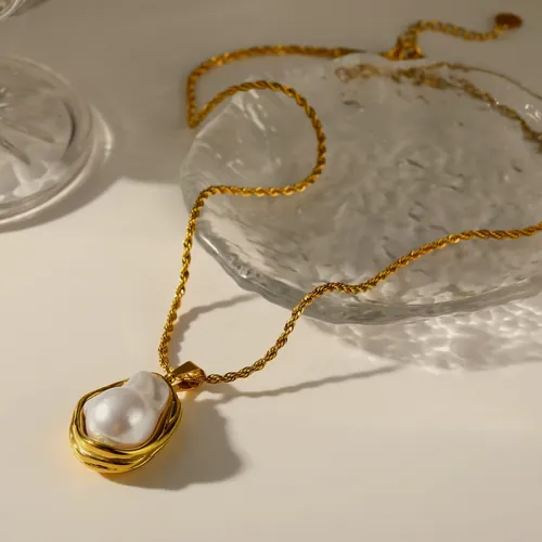 Necklace with a coiled gold drop.