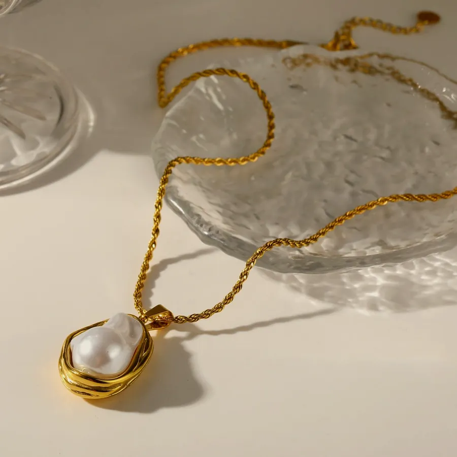 Necklace with a coiled gold drop.