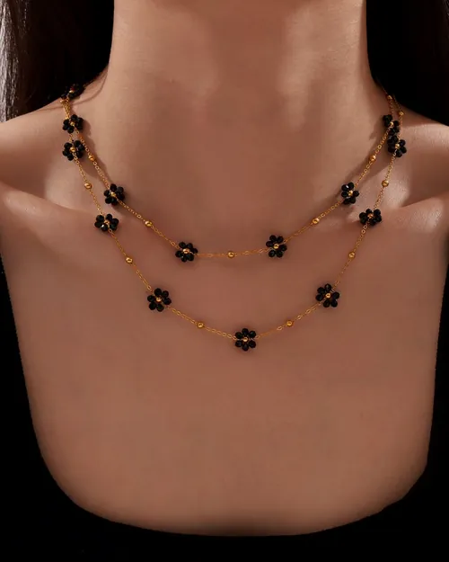 Double black flower necklace, worn.
