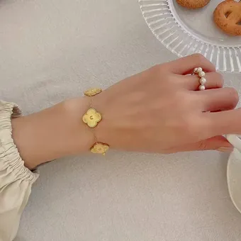 The clover bracelet worn.