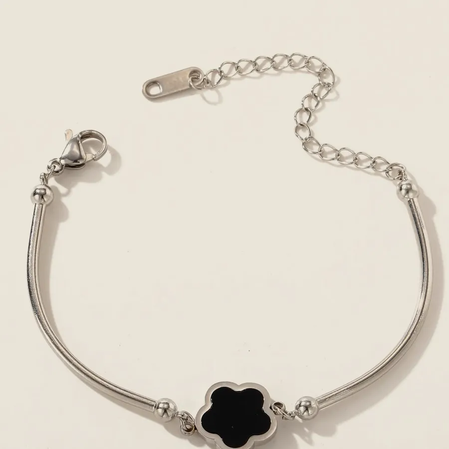Silver-tone bracelet with a black clover.