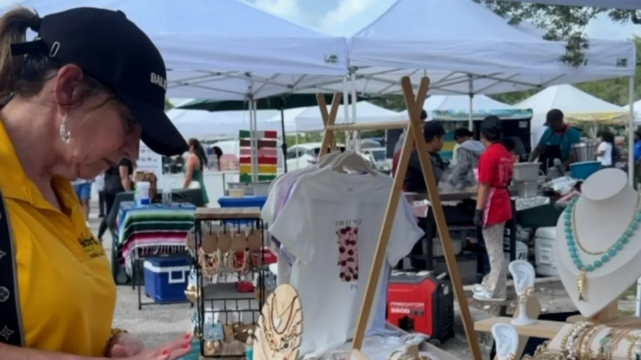 A customer looking at the KORA displays at the booth.