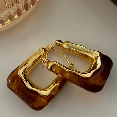Square amber resin and gold hoops.