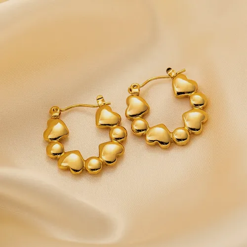 Gold hoops made of hearts in a row.