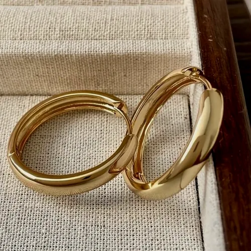 Plain gold hoops on light fabric.