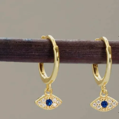 Gold hoops with a blue evil eye charm.