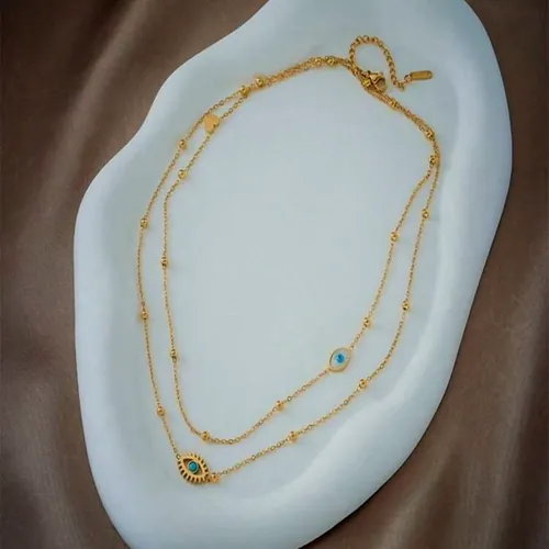 Layered chain necklace with an evil eye.