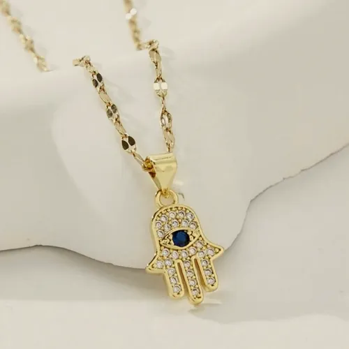 Necklace with a gold hamsa pendant.