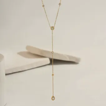 Gold lariat necklace with cubic zirconia.