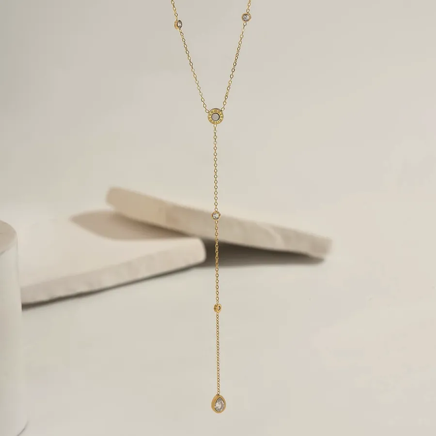 Gold lariat necklace with cubic zirconia.