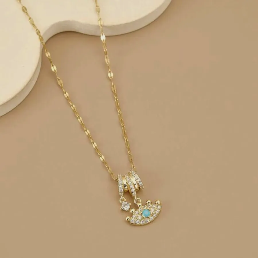 Necklace with a moon charm and cubic zirconia.