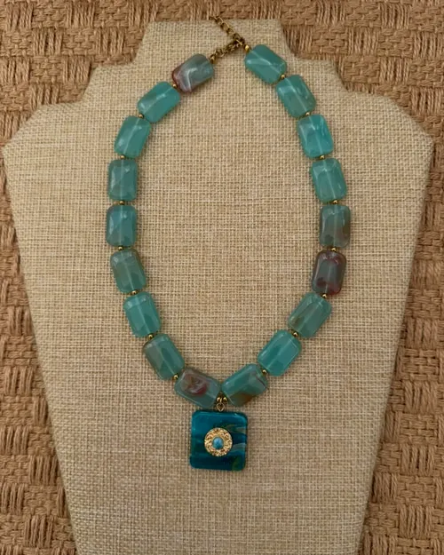 Turquoise choker on a bust.