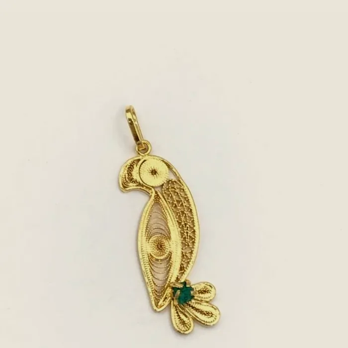 Filigree macaw pendant on a white background.