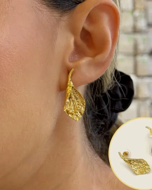 Woven gold leaf earrings, worn.