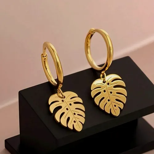 Gold monstera leaf earrings.