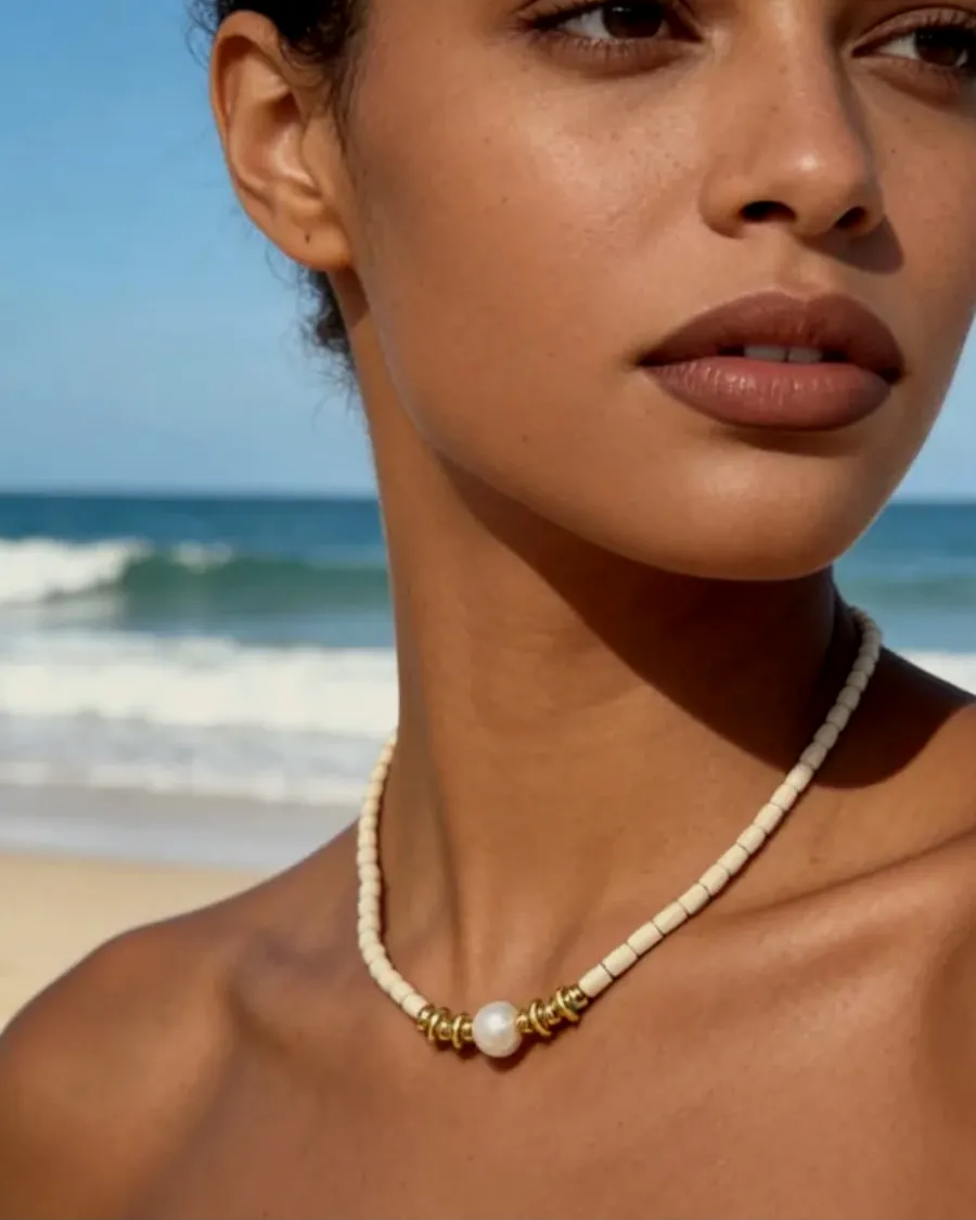 Pearl necklace worn, at the beach.