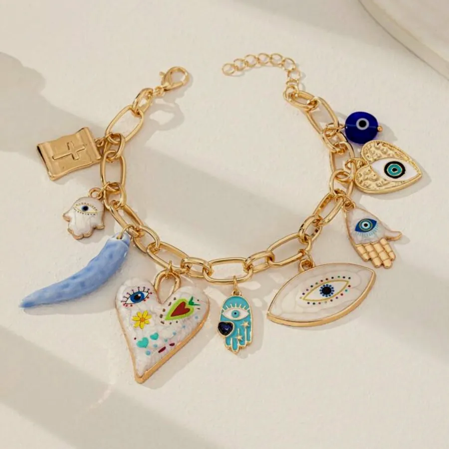 Gold bracelet with evil eye charms.