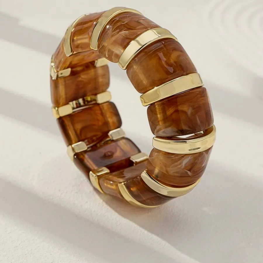 Amber resin bracelet with gold details.
