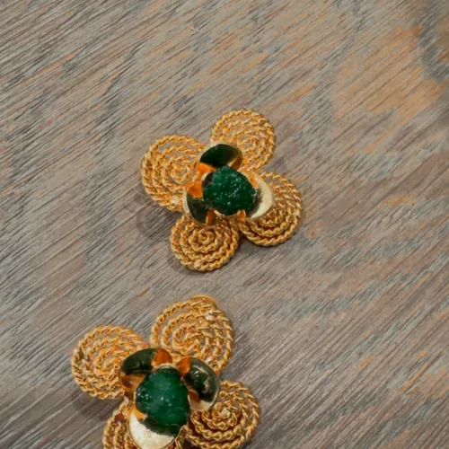 Woven clover flower earrings with an emerald centre.