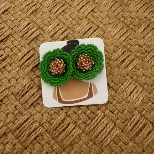 Green woven clover flower earrings with emerald.
