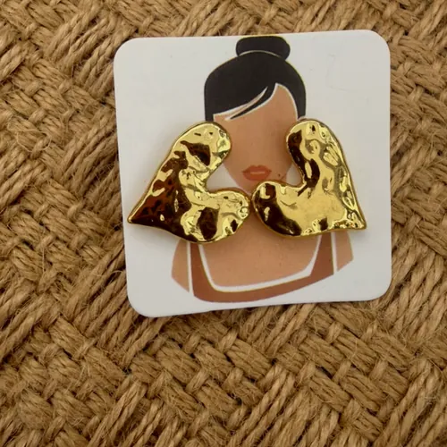 Gold ear climbers on an illustrated card.