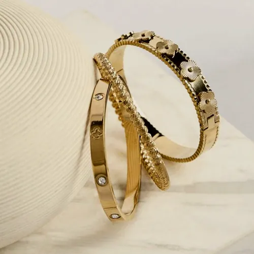 Pair of bangles with celestial motifs.