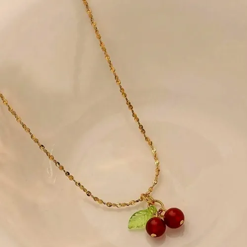 Necklace with a red cherry charm.