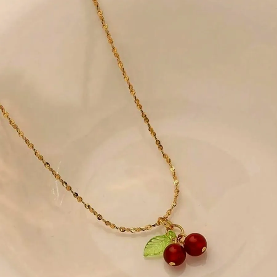 Necklace with a red cherry charm.