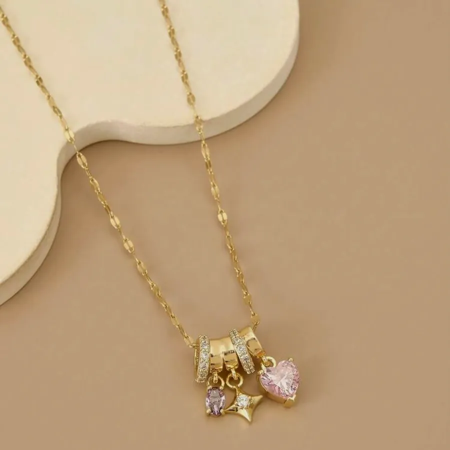 Fine necklace with a gold charm cluster.
