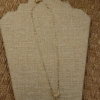 Necklace with a white flower and gold centre.