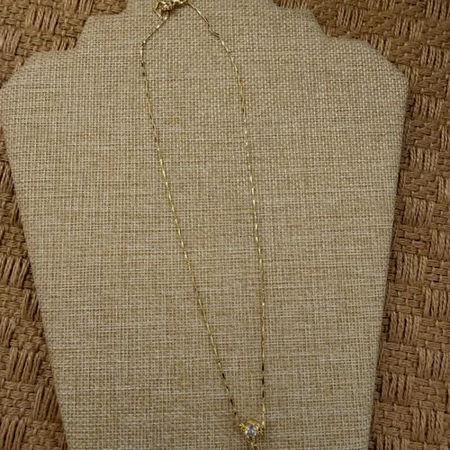 Necklace with a white flower and gold centre.